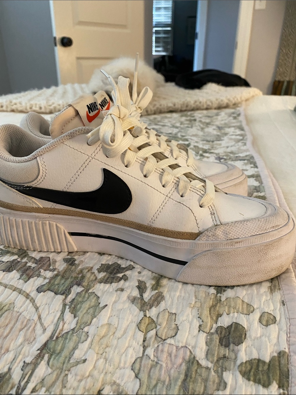 Nike Women's White Sneakers with Black Swoosh and Gold Accent